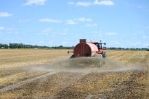 Decorative image of tractor fertilizing a field